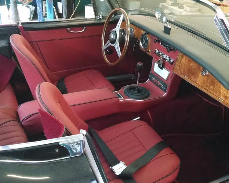 Austin Healey BJ8 trimmed with Matador Red Vinyl Panels, Full Leather Seats and Armrest with Black Piping and Red Wool Carpet