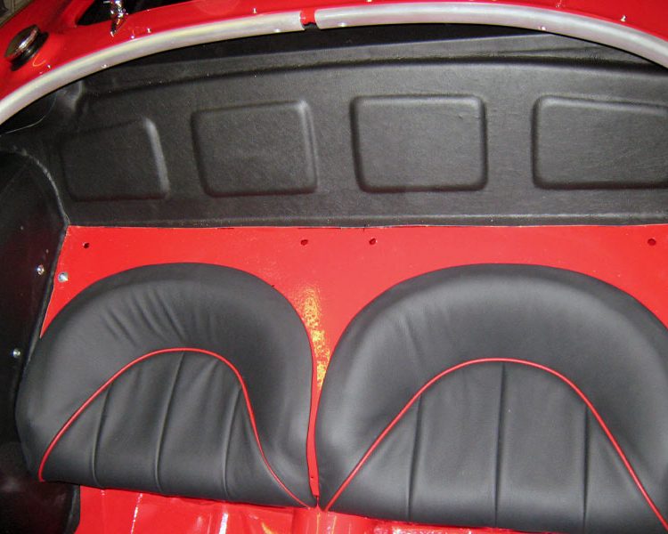 Austin Healey BN4 trimmed with Black Vinyl Rear Bulkhead Hood Stowage Area, Black LeatherFaced Rear Seats with Cherry Red Piping