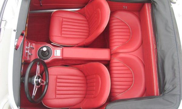 Austin Healey BJ8 trimmed with Cherry Vinyl Panels, Seats and Armrest with Chrome Piping and Bright Red Wool Carpet