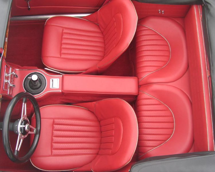 Austin Healey BJ8 trimmed with Cherry Vinyl Panels, Seats and Armrest with Chrome Piping and Bright Red Wool Carpet