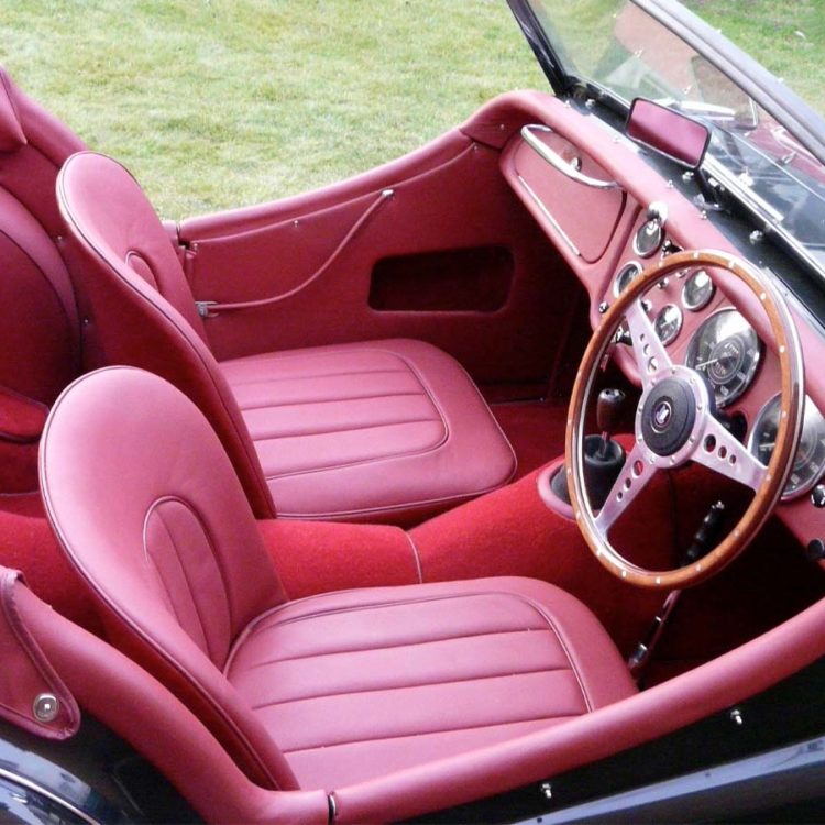 Triumph TR2 fitted with Matador Red Vinyl Interior Trim Panels, Leather Cappings, LeatherFaced Seat Covers, and Red Wool Carpets.