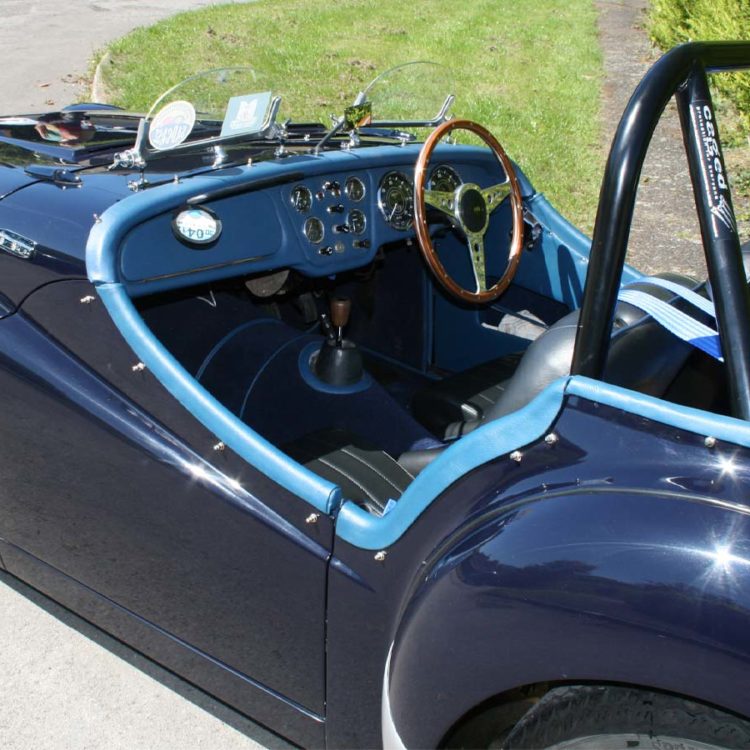Triumph TR2 fitted with Midnight Blue Vinyl Dashboard Facia Panel, Leather Cockpit Cappings, and Dark Blue Wool Carpets.