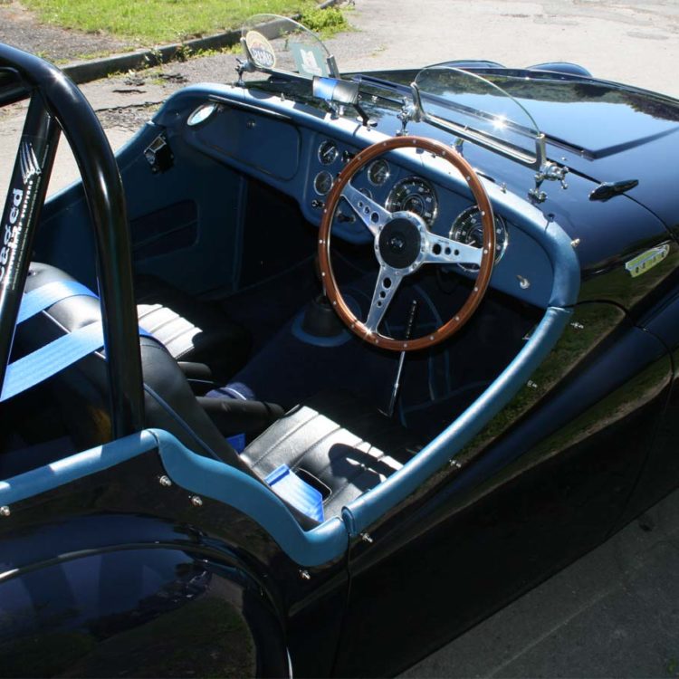 Triumph TR2 fitted with Midnight Blue Vinyl Dashboard Facia Panel, Leather Cockpit Cappings, and Dark Blue Wool Carpets.