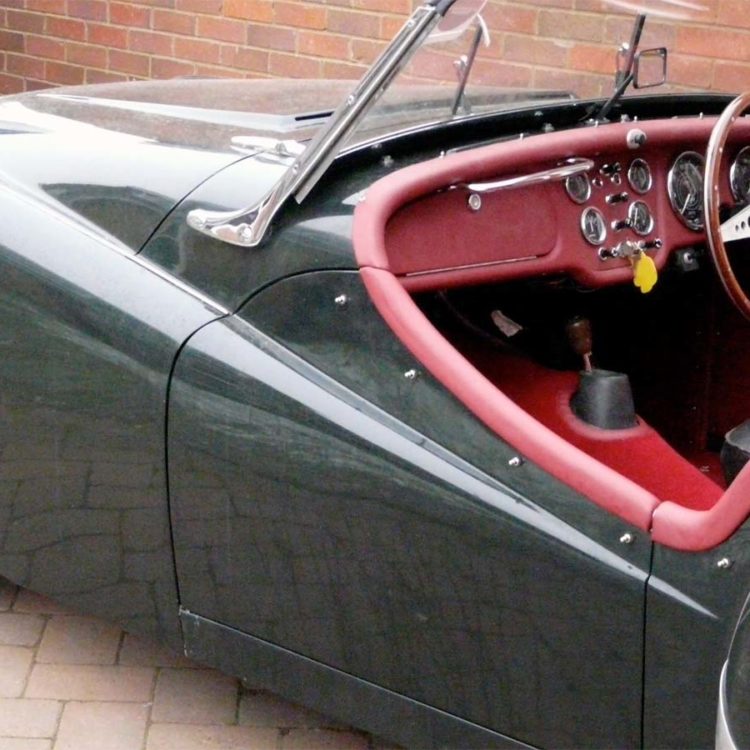 Triumph TR2 fitted with Matador Red Vinyl Dashboard Facia Panel, Leather Cockpit Cappings, and Red Wool Carpets.