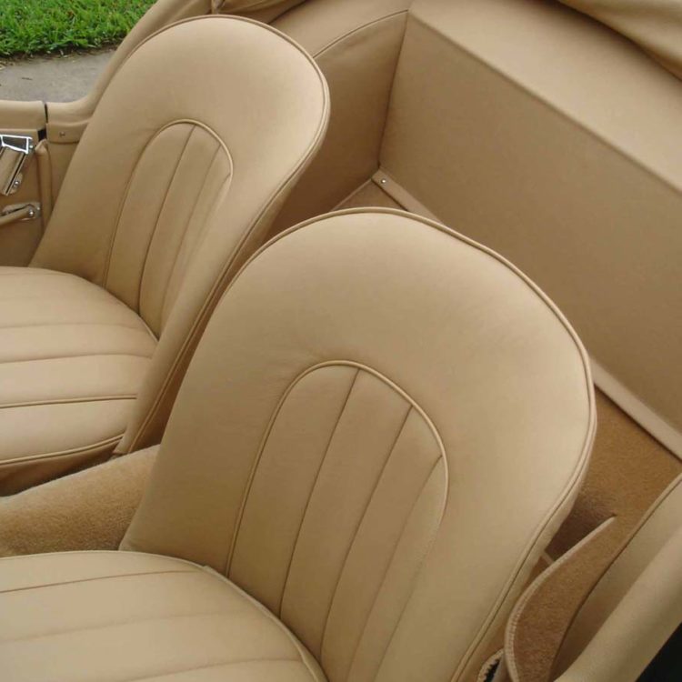 Triumph TR2 fitted with Biscuit Light Tan Leather Interior Panels, Front Seat Covers, and Palomino Wool Carpets.
