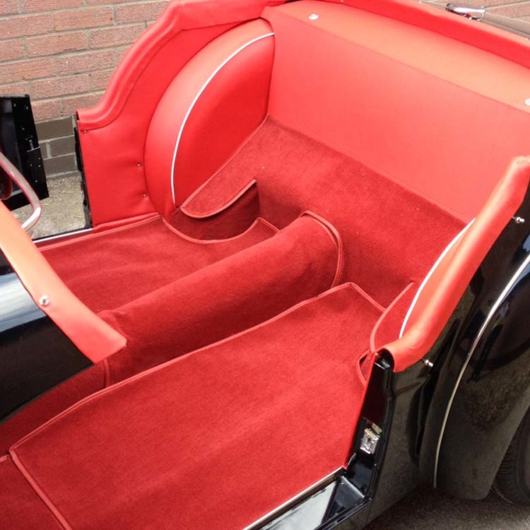 Triumph TR3 fitted with Bright Red Vinyl Interior Trim Panels; with a Red Nylon Carpet Set.