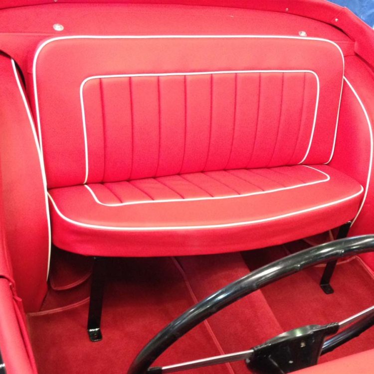 Triumph TR3 fitted with Bright Red Vinyl Rear Seats, and Interior Trim Panels; with a Red Nylon Carpet Set.