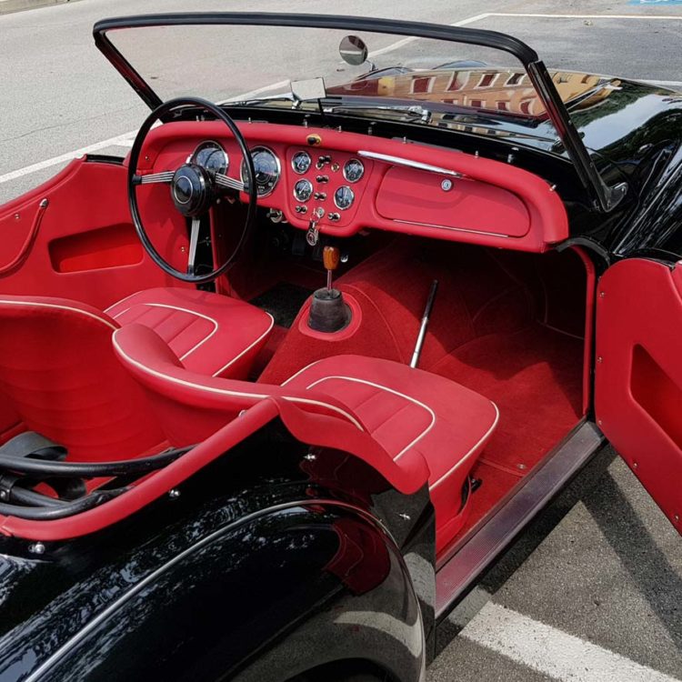 Triumph TR3 fitted with Bright Red Vinyl Interior Trim Panels, Leather Cappings, LeatherFaced Seat Covers, and a Bright Red Wool Carpet Set.