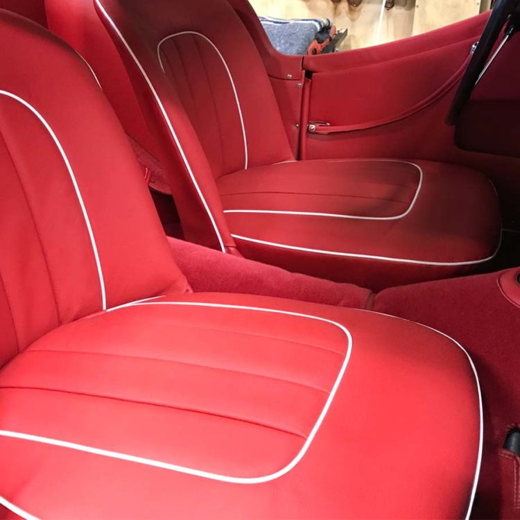 Triumph TR3 fitted with Bright Red Vinyl Interior Panels, LeatherFaced Seat Covers, and Bright Red Wool Carpets.