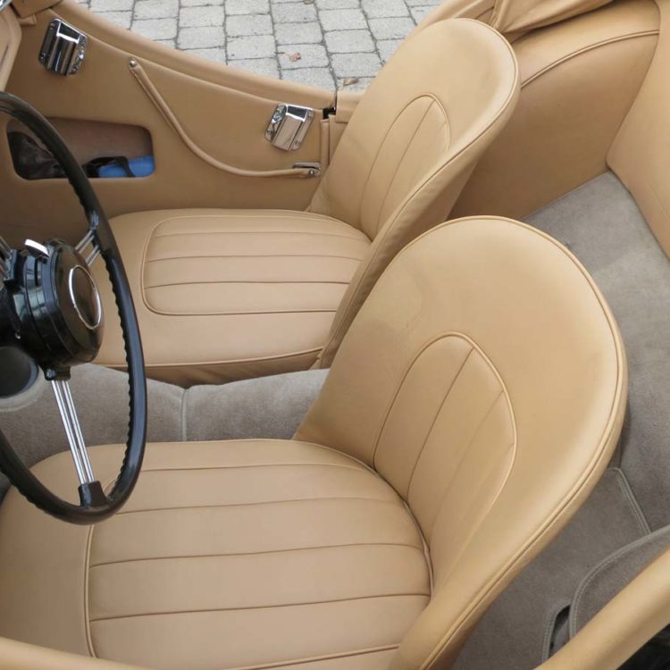 Triumph TR3 fitted with Biscuit Light Tan Leather Seat Covers, Interior Trim Panels, Hood Frame Cover; and Fawn Wool Carpets.