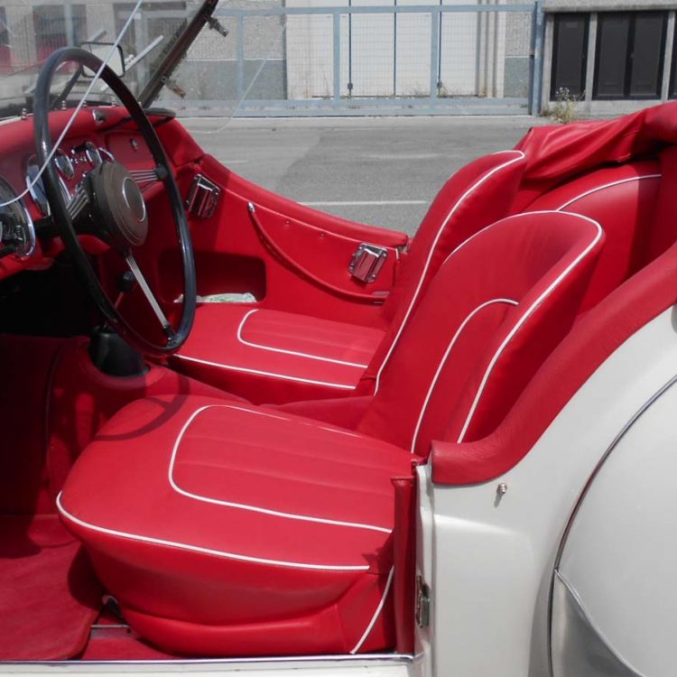 Triumph TR3 fitted with Red Carpets, & Bright Red Vinyl Interior Panels, Leather Cappings & Seat Covers, with a Vinyl Hood Frame Cover.