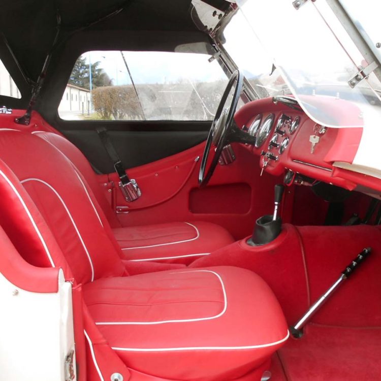 Triumph TR3 fitted with Bright Red Vinyl Interior Panels, Leather Cappings and Seat Covers, with a Black PVC Everflex Soft Top Hood.