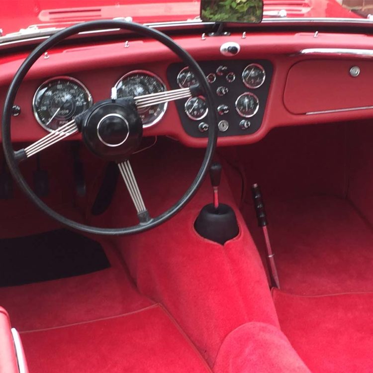 Triumph TR3A/B fitted with Cherry Red Vinyl Dashboard Facia, Leather Cappings, and Bright Red Wool Carpets.
