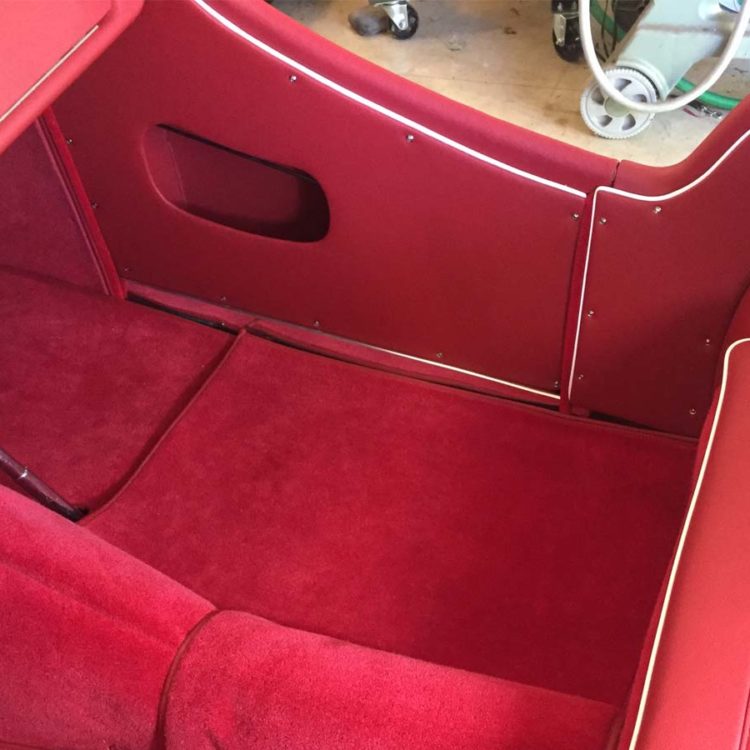Triumph TR3A/B fitted with Cherry Red Vinyl Trim Panels, Leather Cappings, LeatherFaced Rear Seats, and Bright Red Wool Carpets.