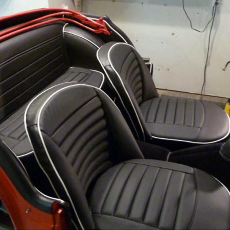 Triumph TR3A fitted with Black Vinyl Rear Bulkhead Panel, LeatherFaced Rear Seat, Leather Cappings, and Black Wool Carpets.