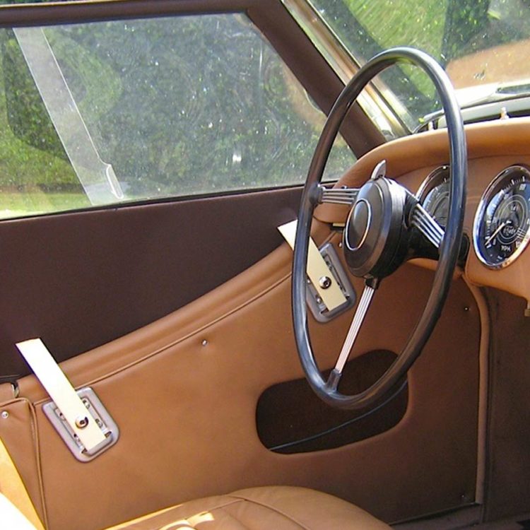 Triumph TR3A/B fitted with Cinnamon Leather Door Panels, Cappings and Dash Facia, and Dark Brown Mohair Sidescreens.
