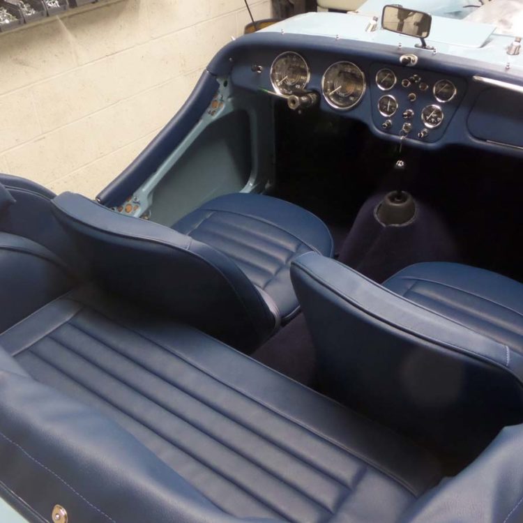 Triumph TR3A/B fitted with AH Blue Vinyl Interior Trim Panels, Hood Frame Cover, Front & Rear Seat Covers, and Dark Blue Wool Carpets.