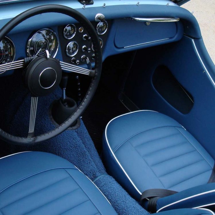 Triumph TR3A Dashboard Facia Panel trimmed with Midnight Blue Vinyl, Leather Cappings, and LeatherFaced Front Seat Covers.
