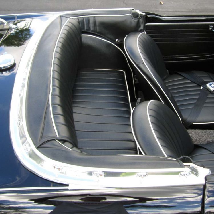 Triumph TR4 fitted with Black Vinyl Rear 3pc Hood Stowage Cover, Rear Seat Cushion Base, and Front Seat Covers (“Early Style”).