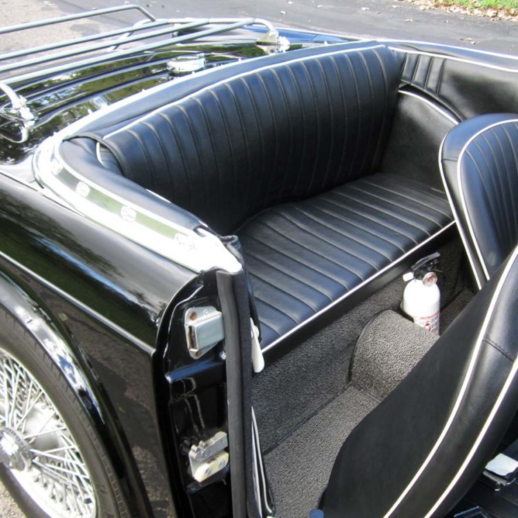 Triumph TR4 fitted with Black Vinyl Rear 3pc Hood Stowage Cover, Rear Seat Cushion Base, and Front Seat Covers ("Early Style").