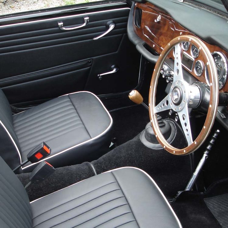 Triumph TR4 fitted with a Black Vinyl Door Panel trims, and LeatherFaced Front Seat Covers, with Black Wool Carpets.