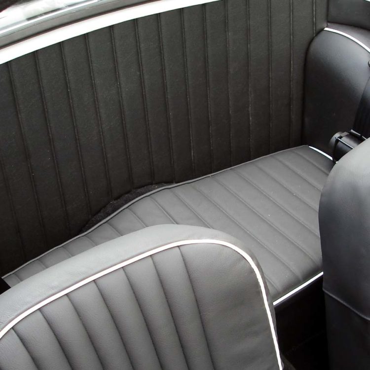 Triumph TR4 fitted with a Black Vinyl Bulkhead Panel, Wheelarchs, and LeatherFaced Front & Rear Seats.