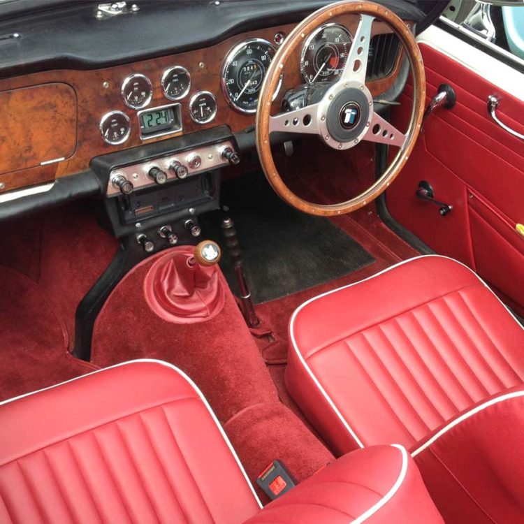 Triumph TR4 fitted with Cherry Red Vinyl Trim Panels, Front Seat Covers (“Late Style”), and Nylon Carpets.