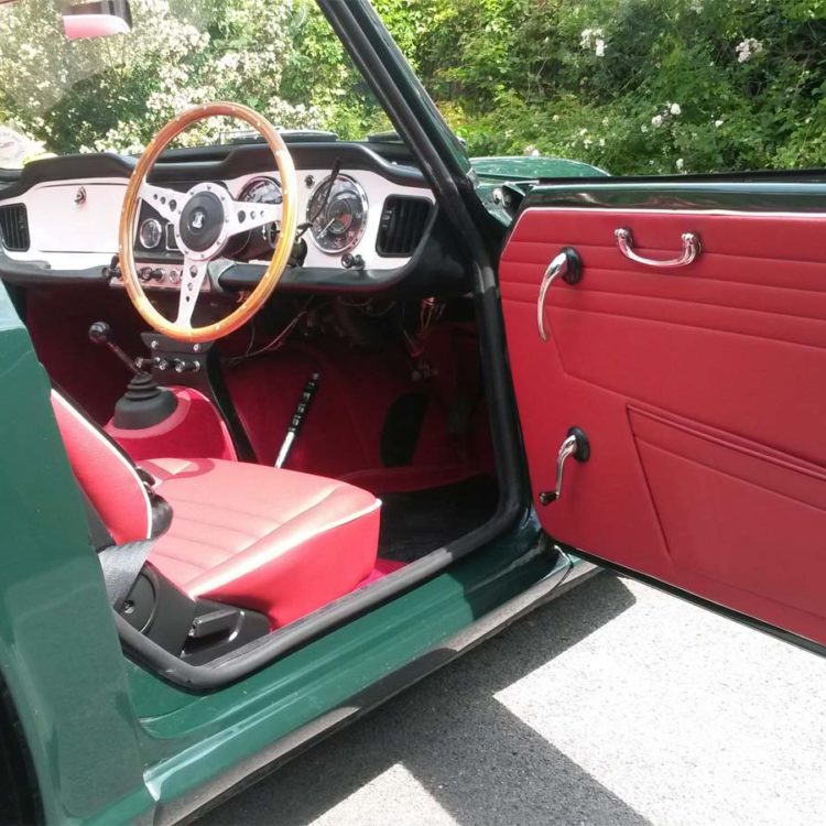 Triumph TR4 fitted with Cherry Red Vinyl Door Panels, and Red Wool Carpets.