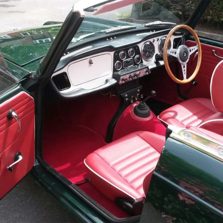 Triumph TR4 fitted with Cherry Red Vinyl Door Panels, and Red Wool Carpets.