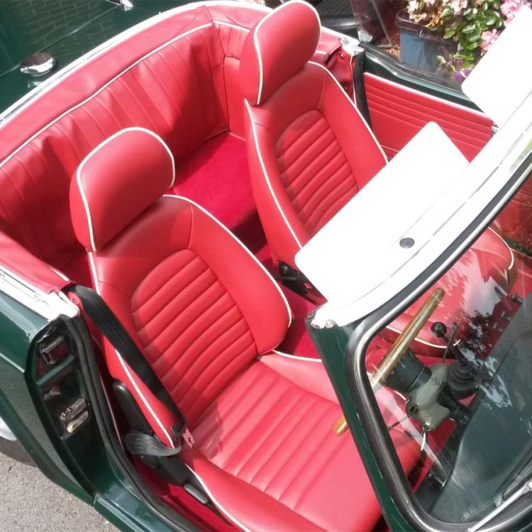 Triumph TR4 fitted with Cherry Red Vinyl 3pc Hood Frame Stowage, with Red Wool Carpets, and White PVC Sunvisors.
