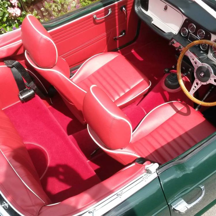 Triumph TR4 fitted with Cherry Red Vinyl Interior Trim Panels, and 3pc Hood Frame Stowage, with Red Wool Carpets.
