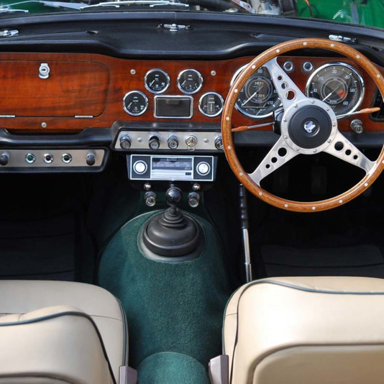 Triumph TR4 fitted Stone Leather Front Seat Covers ("Late Style"), Vinyl Trim Panels, and Dark Green Wool Carpets.