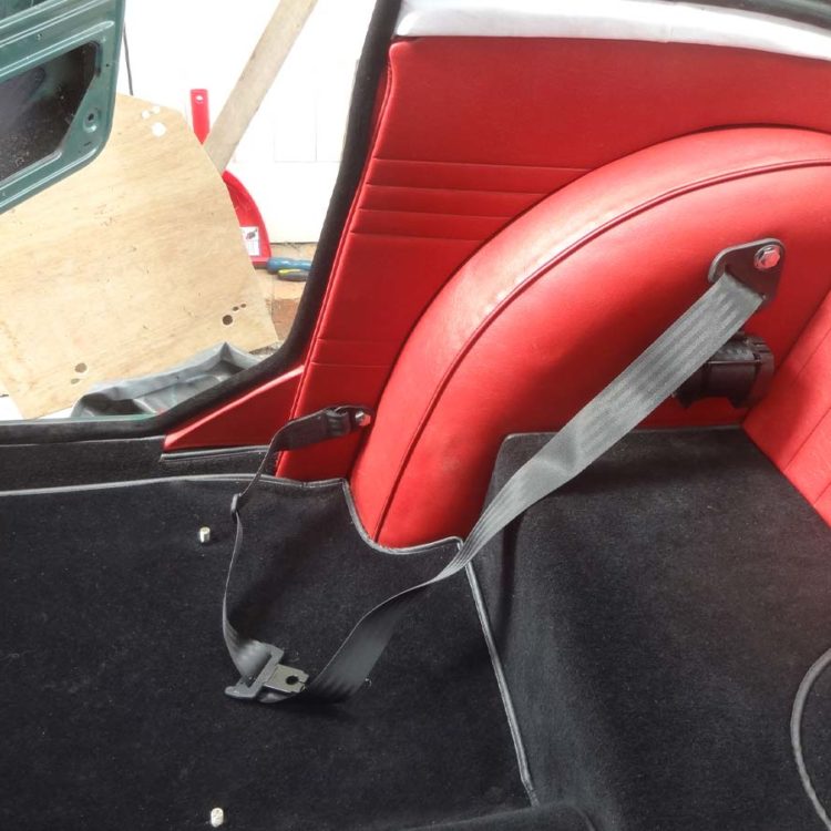 Triumph TR4 fitted with a Black Wool Carpets, and Cherry Red Vinyl B Post, Quarter, and Wheelarch Covers.