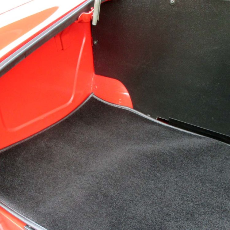 Triumph TR4 fitted with a Black Wool Boot Mat Carpet, and Blackgrain Millboard Fuel Tank Board.