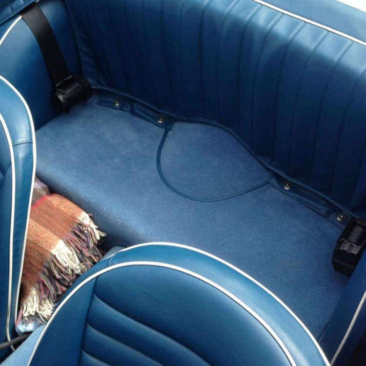 Triumph TR4 fitted with Midnight Blue Vinyl Seat Covers, Rear 3pc Hood Frame Stowage Cover, and Shadow Blue Wool Carpets.