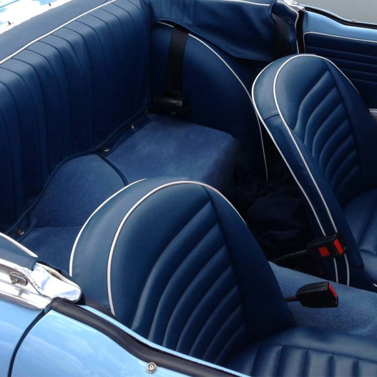 Triumph TR4 fitted with Midnight Blue Vinyl Seat Covers, Rear 3pc Hood Frame Stowage Cover, and Shadow Blue Wool Carpets.