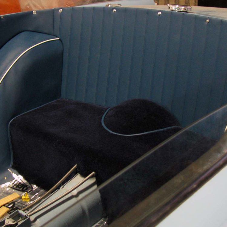 Triumph TR4A fitted with Midnight Blue Vinyl Quarter Panels, Wheelarch Covers, Bulkhead Panel, and Dark Blue Wool Carpets.