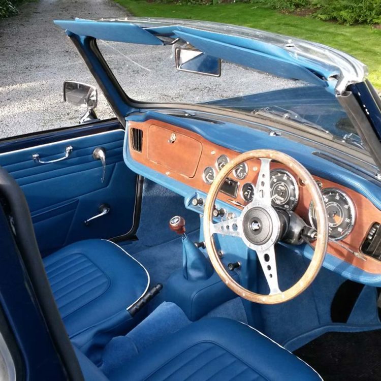 Triumph TR4A fitted with Midnight Blue Vinyl Interior Trim Panels, Front Seat Covers, Sunvisors and Dash Area, with Shadow Blue Wool Carpets.