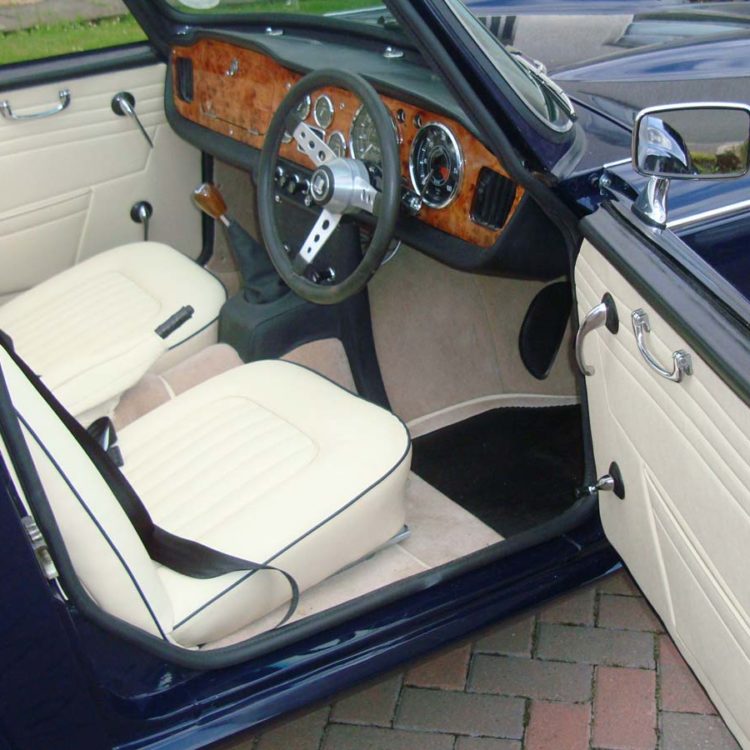 Triumph TR4A fitted with Parchment Vinyl Door Panels, LeatherFaced Front Seats, and Camel Wool Carpets.
