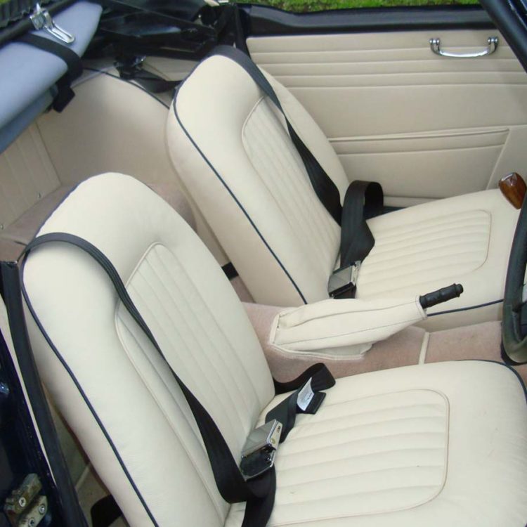 Triumph TR4A fitted with Parchment Vinyl Trim Panels, LeatherFaced Front Seats, and Camel Wool Carpets.