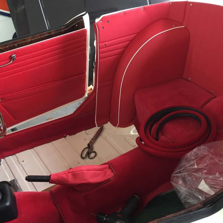 Triumph TR4A fitted with Bright Red Leather Interior Panels, and a Bright Red Wool Carpet Set.