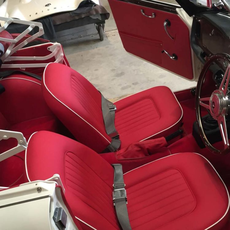 Triumph TR4A fitted with Bright Red Leather Interior Trim Panels, Front Seat Covers, and Bright Red Wool Carpets.