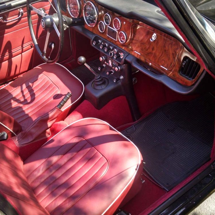 Triumph TR4A fitted with Matador Red LeatherFaced Seats, Vinyl Door Panels, and Red Wool Carpets.