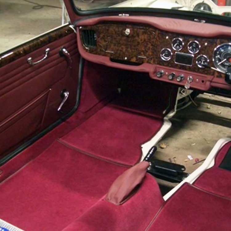 Triumph TR4A fitted with Maroon Leather Interior Trim Panels, Lower Crash Pads, & Switch Plinth, with Wool Carpets.