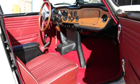 Triumph TR5 / TR250 fitted with Matador Red Vinyl Interior Trim Panels, LeatherFaced Front Seats, a Red Wool Carpet Kit, & Black Vinyl H Frame Cover