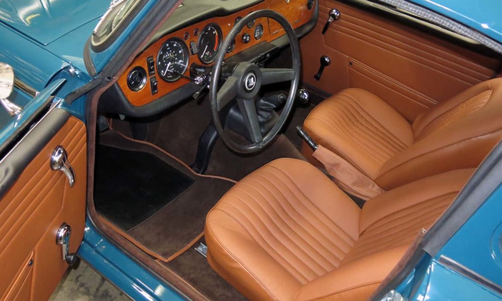 Triumph TR5 / TR250 fitted with New Tan Vinyl Interior Trim Panels, LeatherFaced Front Seats, and Dark Brown Wool Carpets with New Tan Edging.