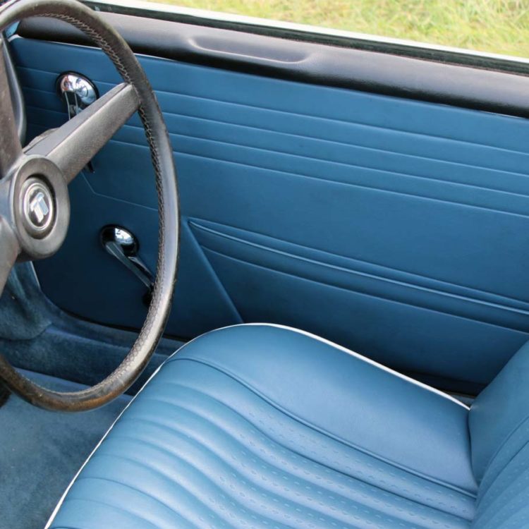 Triumph TR5 / TR250 fitted with Shadow Blue Vinyl Interior Trim Panels, Front Seat Covers, and Shadow Blue Wool Carpets.