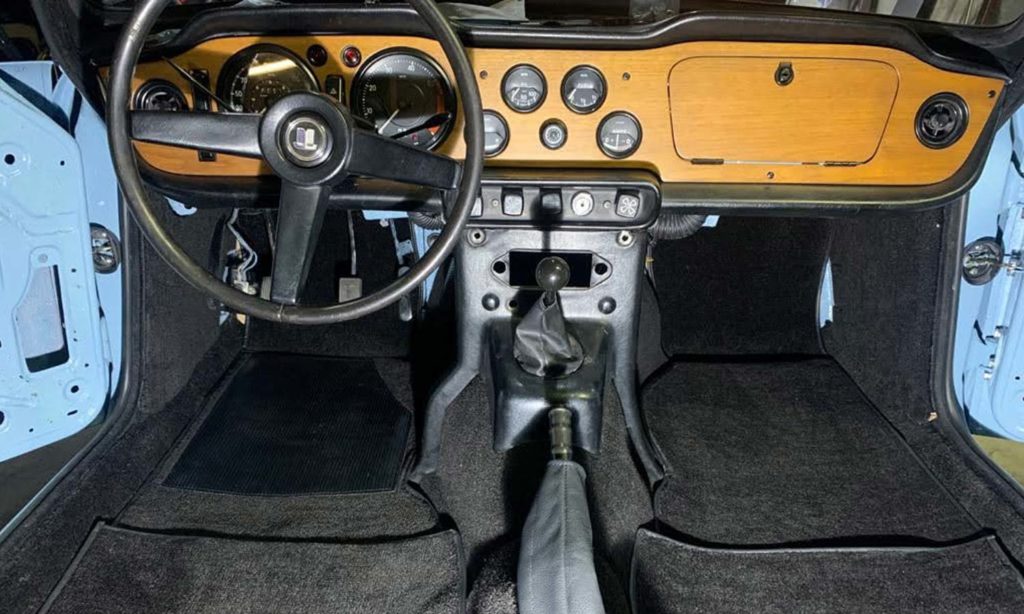 Triumph TR5 / TR250 fitted with a Black Nylon Carpet Set, with Leather Handbrake Cover.