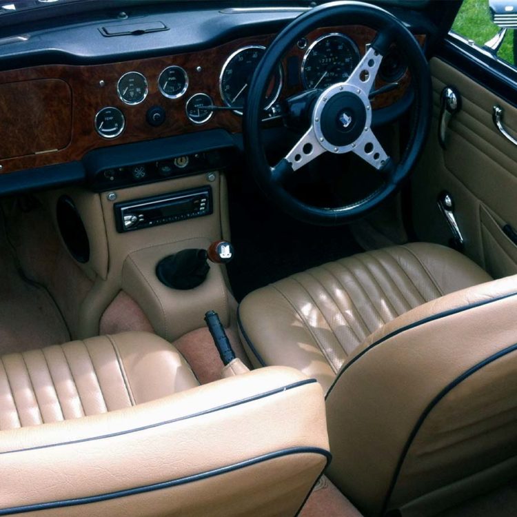 Triumph TR5 / TR250 fitted with Barley Beige Vinyl Trim Panels & Centre Console H Frame, LeatherFaced Front Seats, and Honey Wool Carpets.