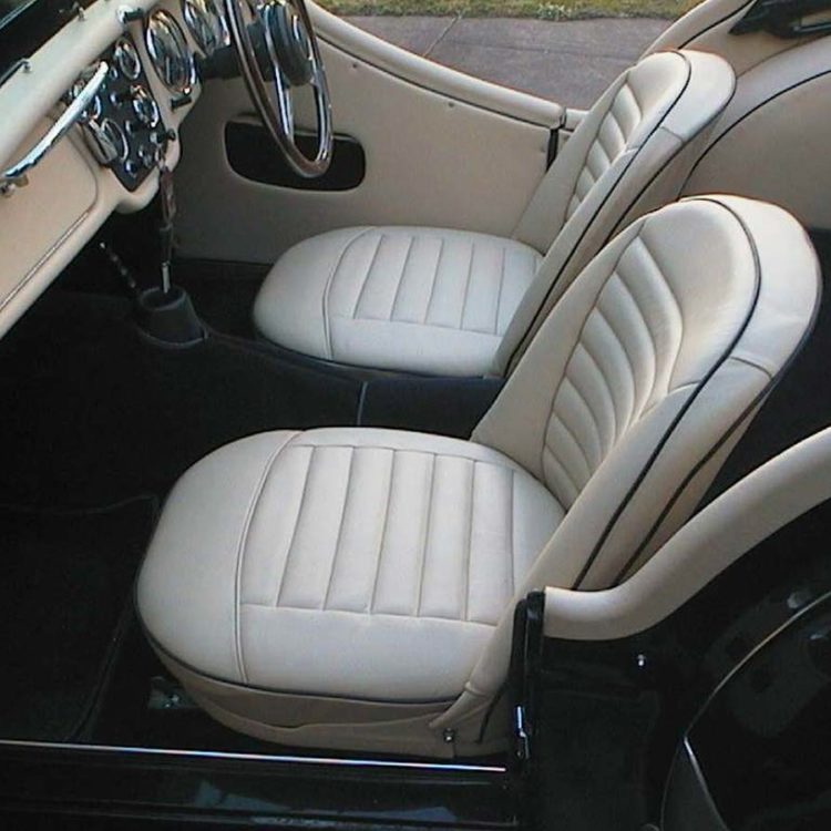 Triumph TR3A fitted with Magnolia Vinyl Trim Panels, Leather Cappings, LeatherFaced Front Seats, and Dark Blue Wool Carpets.